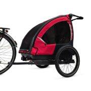 Side view of Nordic Cab bike trailer for kids attached to bike
