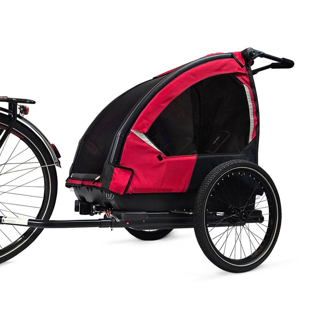 Side view of Nordic Cab bike trailer for kids attached to bike
