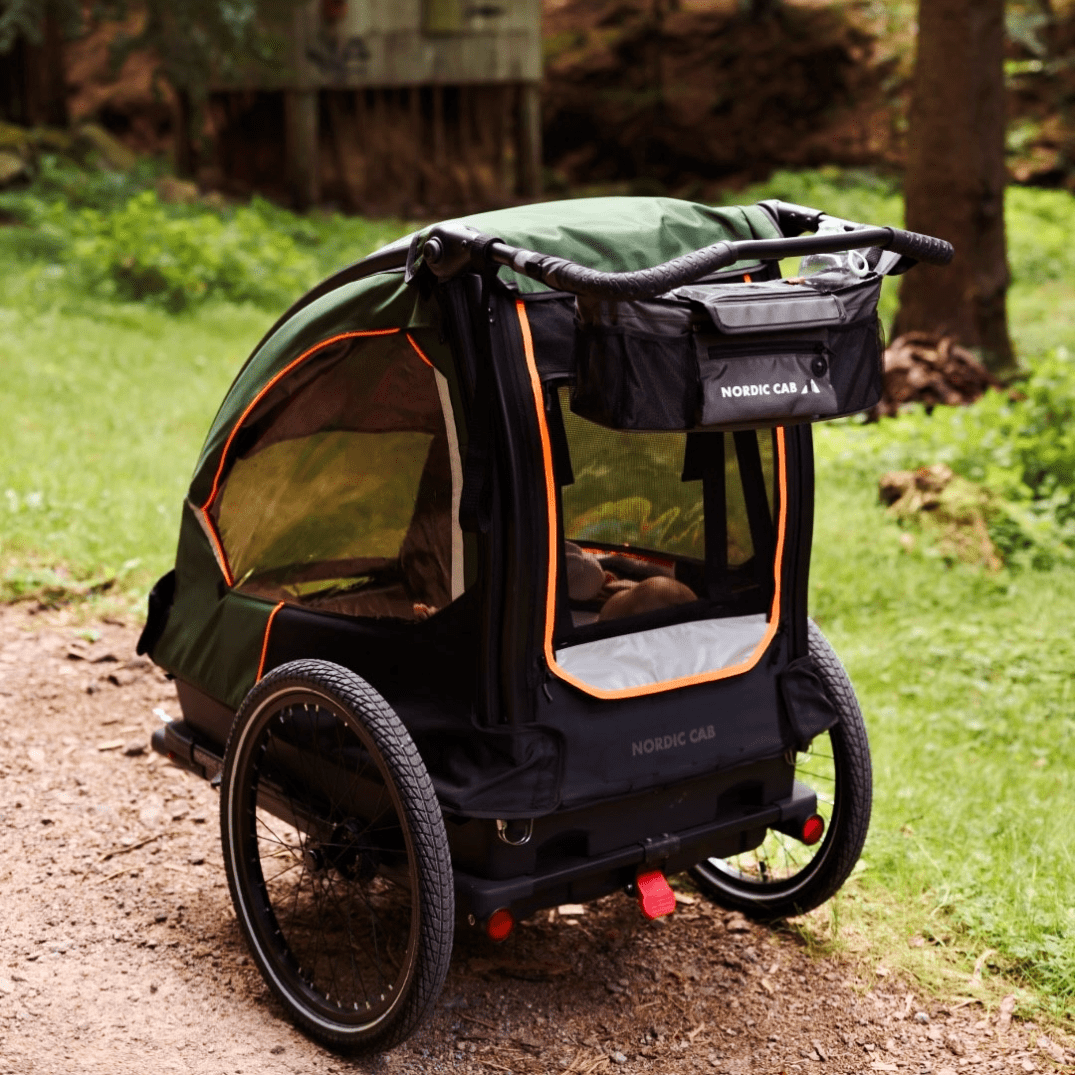 Rear view of Nordic Cab bike trailer showing storage space and handlebar.